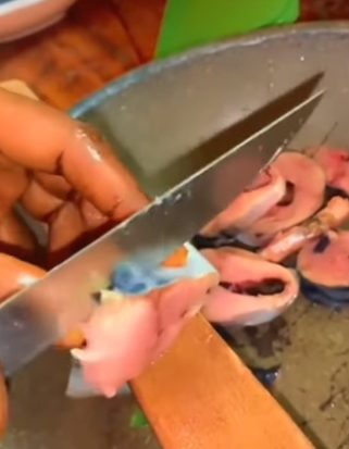 Nigerian Woman Creates a Buzz Over Video Of Slicing Titus Fish Into Tiny Pieces